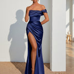 Navy blue satin off-shoulder gown with a high slit on a white background