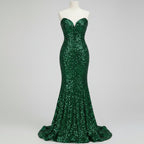 Green sequin dress worn by a person on a white background
