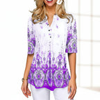 Woman wearing a white blouse with purple floral patterns on a gray background