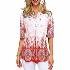 Woman wearing a patterned blouse with a gray background