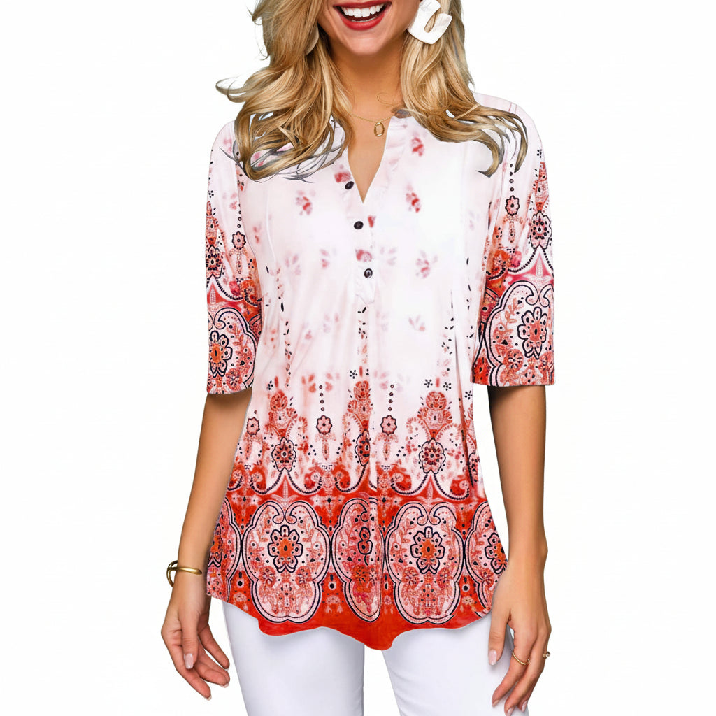 Woman wearing a patterned blouse with a gray background