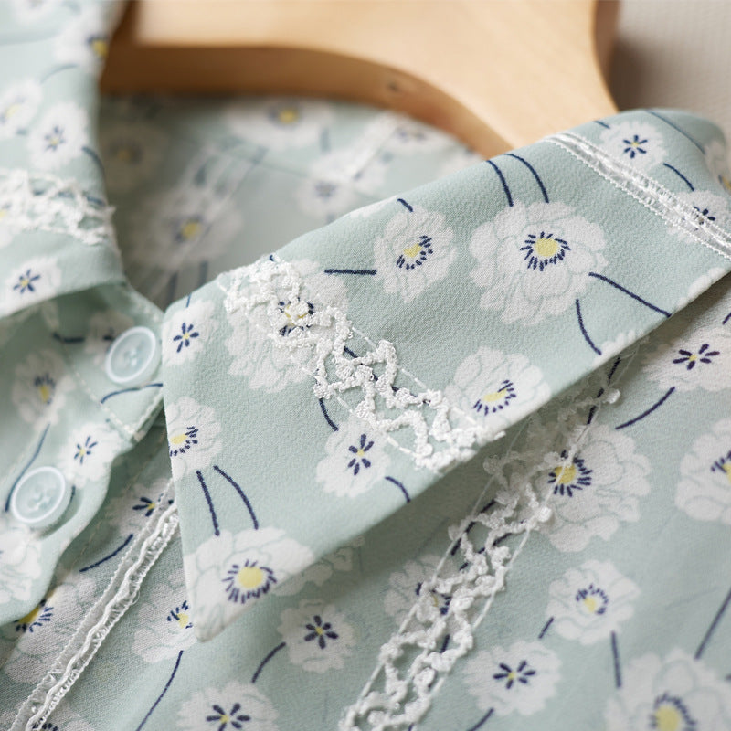 Light blue fabric with floral pattern and lace trim on a wooden surface