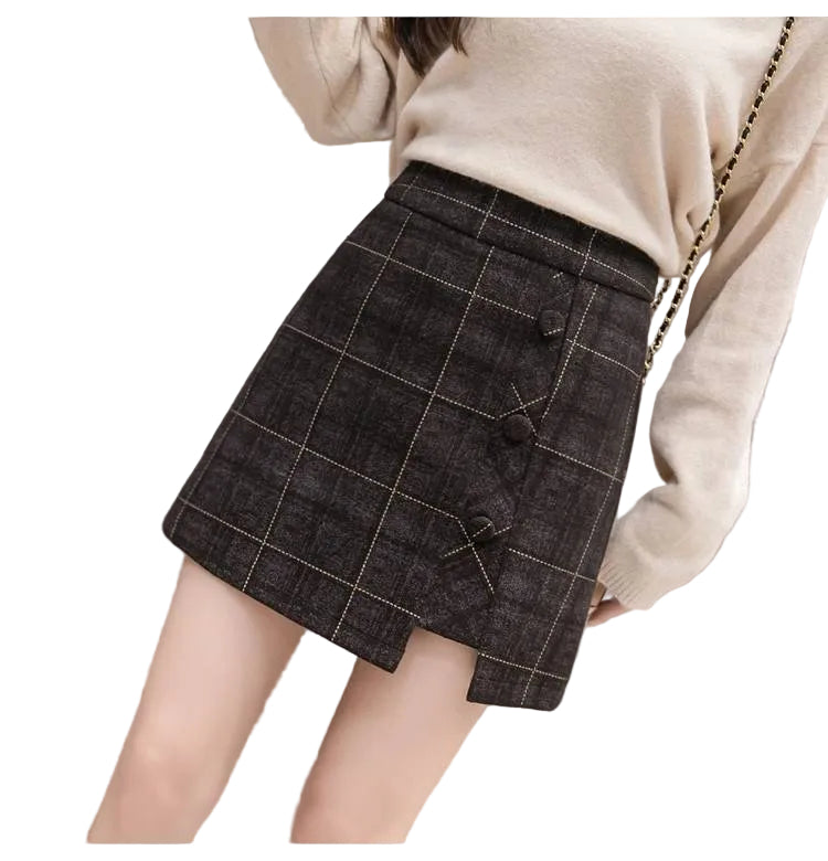 Person wearing a plaid skirt on a tiled floor