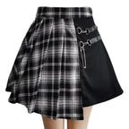 Black and white plaid skirt with metal accents on a gray background