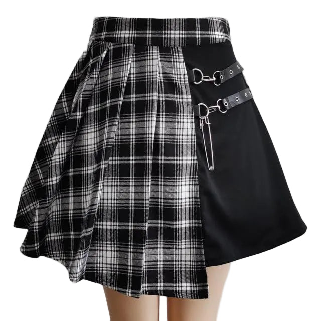 Black and white plaid skirt with metal accents on a gray background
