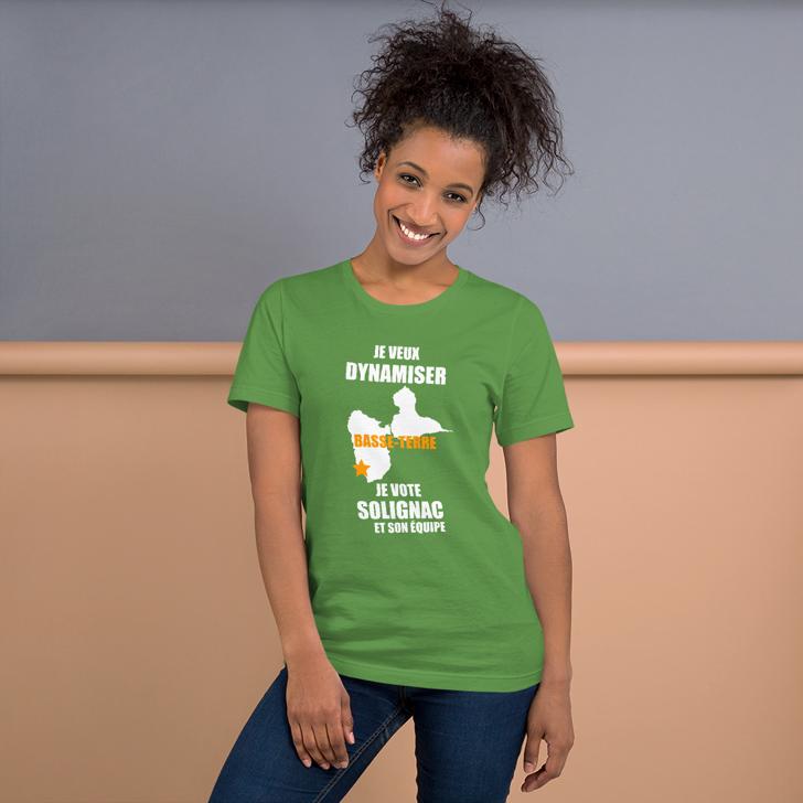 Woman wearing a green t-shirt with text and graphics on a plain background