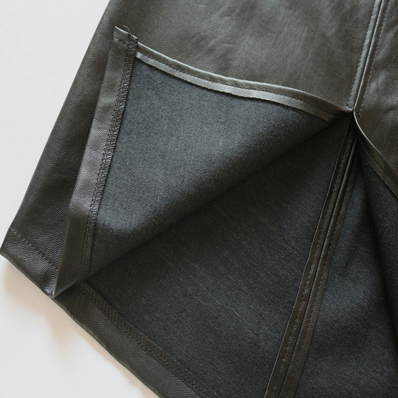 Close-up of a dark gray fabric with a pocket detail on a light gray background