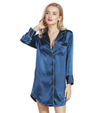 Woman wearing a blue satin nightshirt against a white background