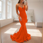 Orange evening gown worn by a model on a white background