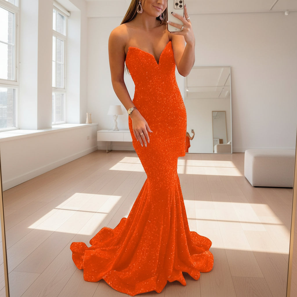 Orange evening gown worn by a model on a white background