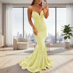 Woman wearing a strapless, light green evening gown on a white background