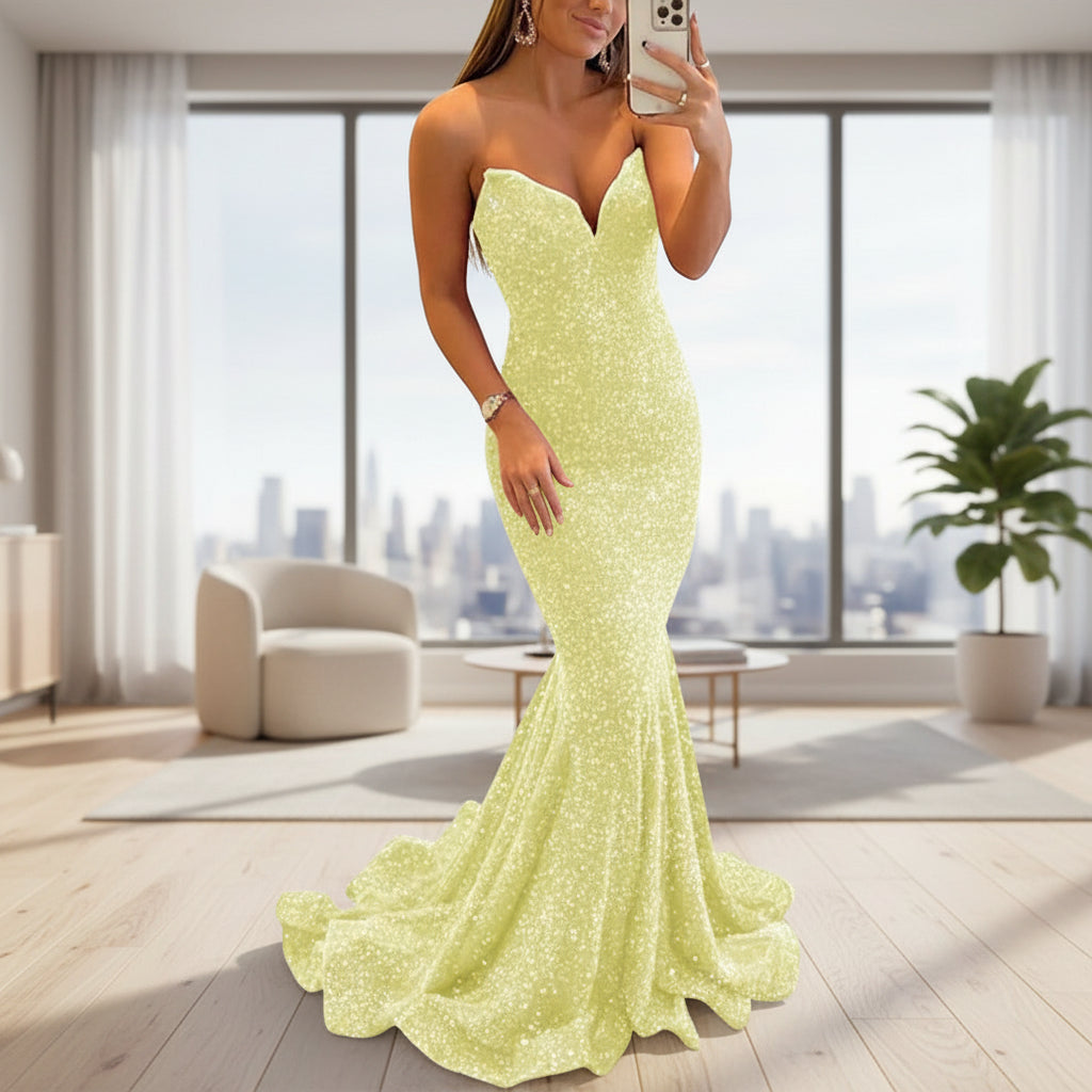 Woman wearing a strapless, light green evening gown on a white background