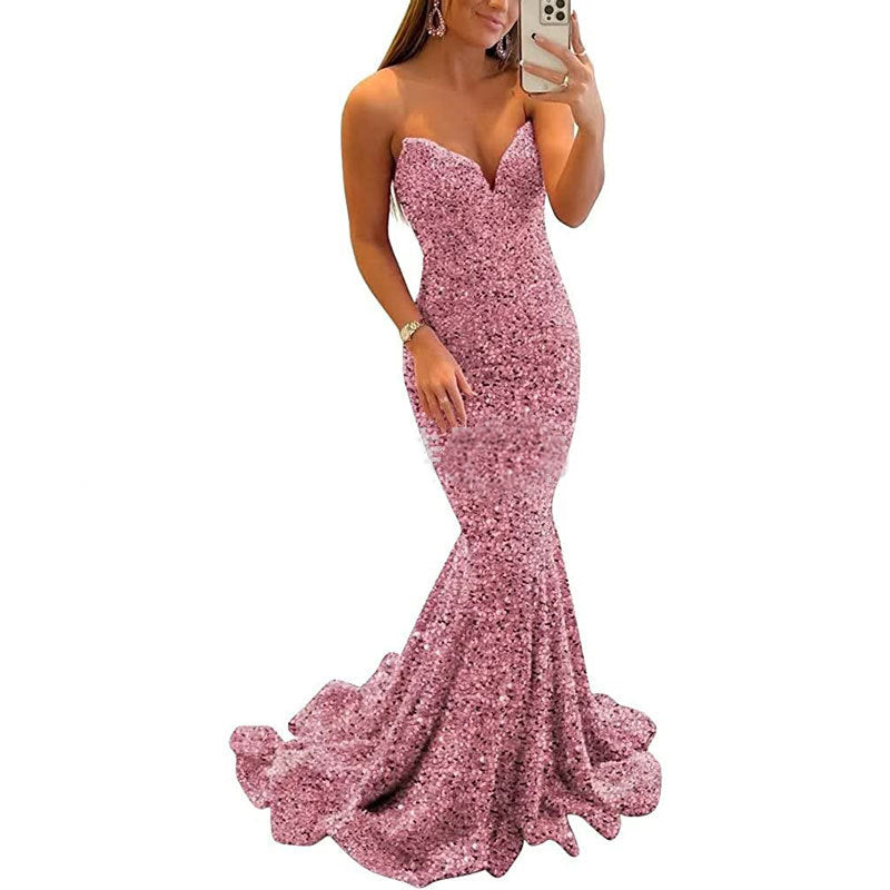 Pink sequin dress worn by a person on a white background