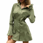 Woman wearing a green shirt dress against a neutral background