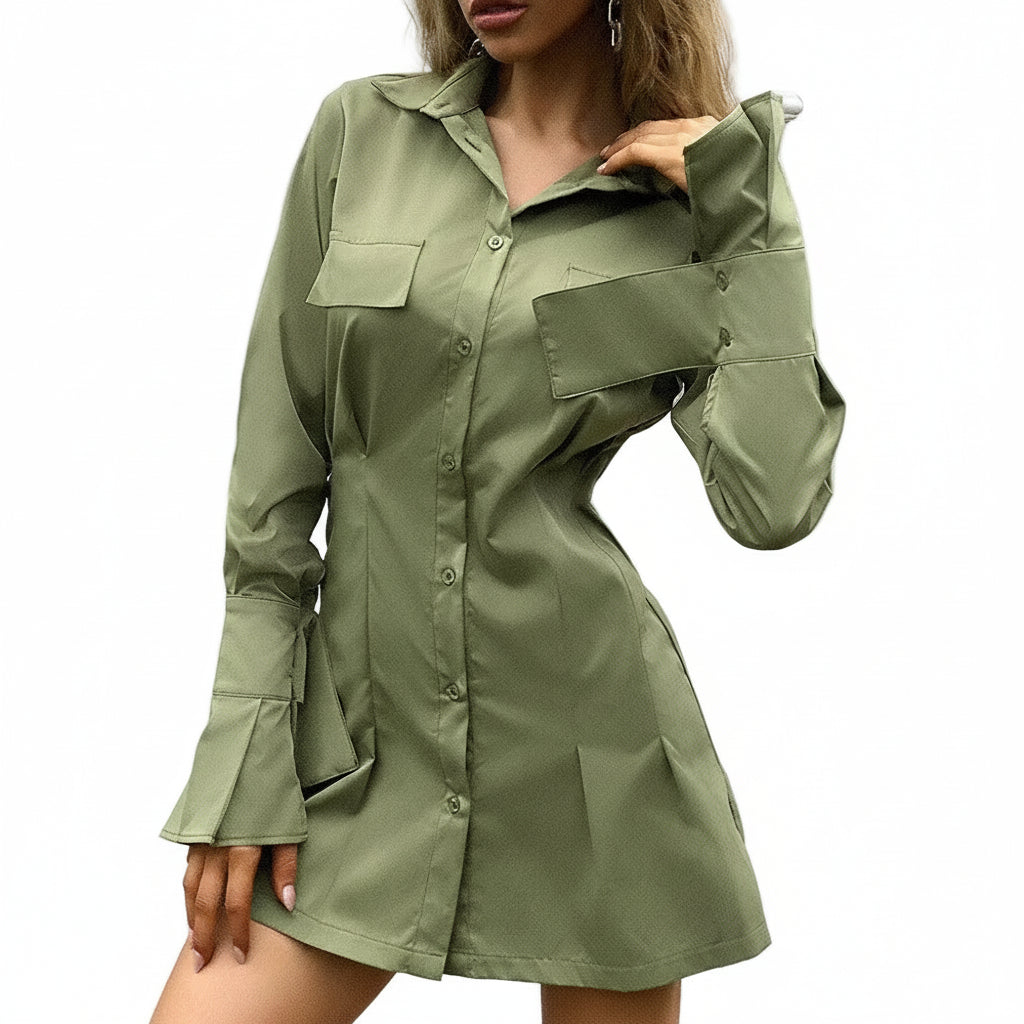 Woman wearing a green shirt dress against a neutral background